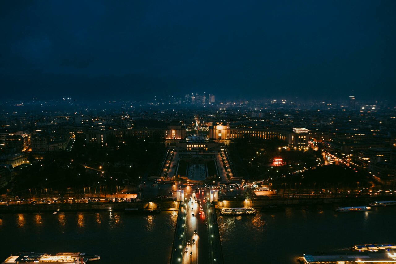 Stunning nighttime aerial cityscape of Paris highlighting iconic landmarks.